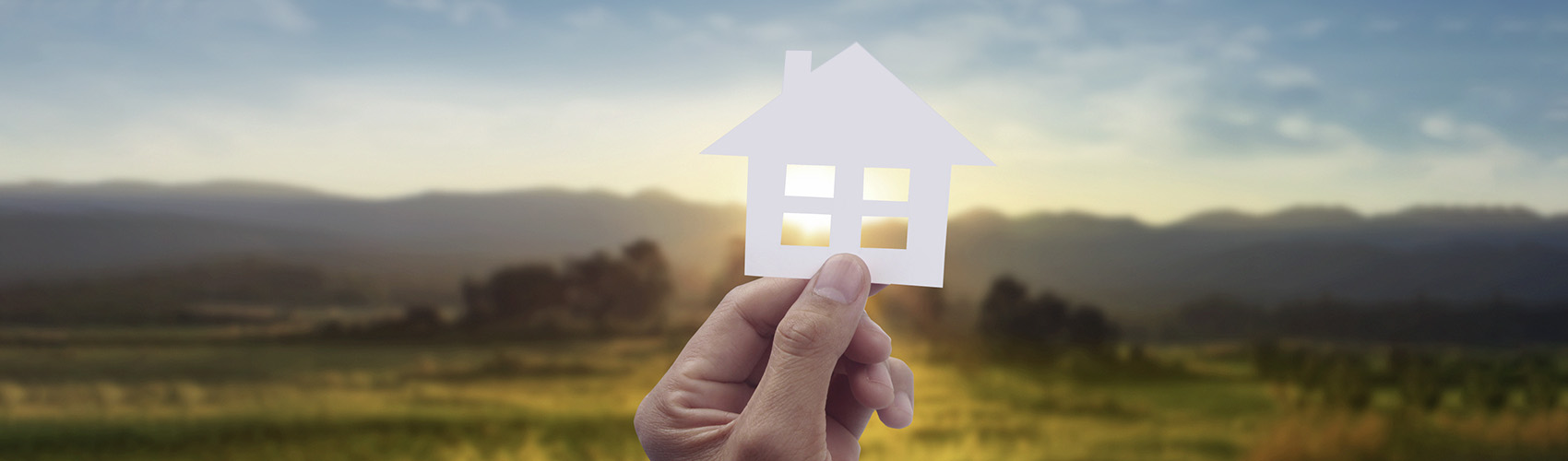 Hands holding paper house, family home